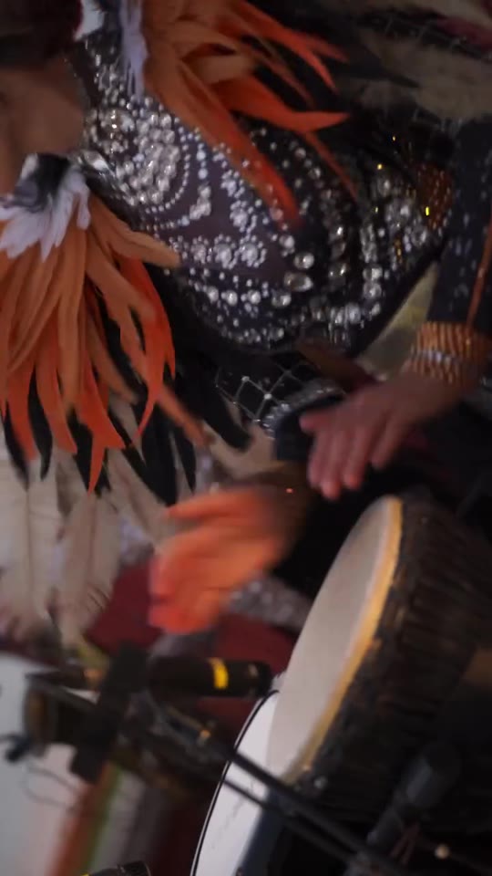 Close-up drummer in feather headdress, Bastian Riviera Goa